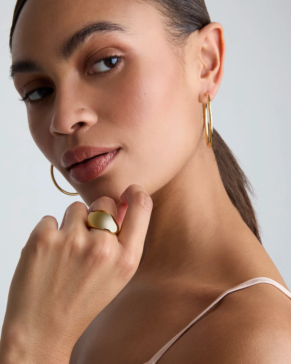Thin Large Hoop Earrings in Gold - Image 2